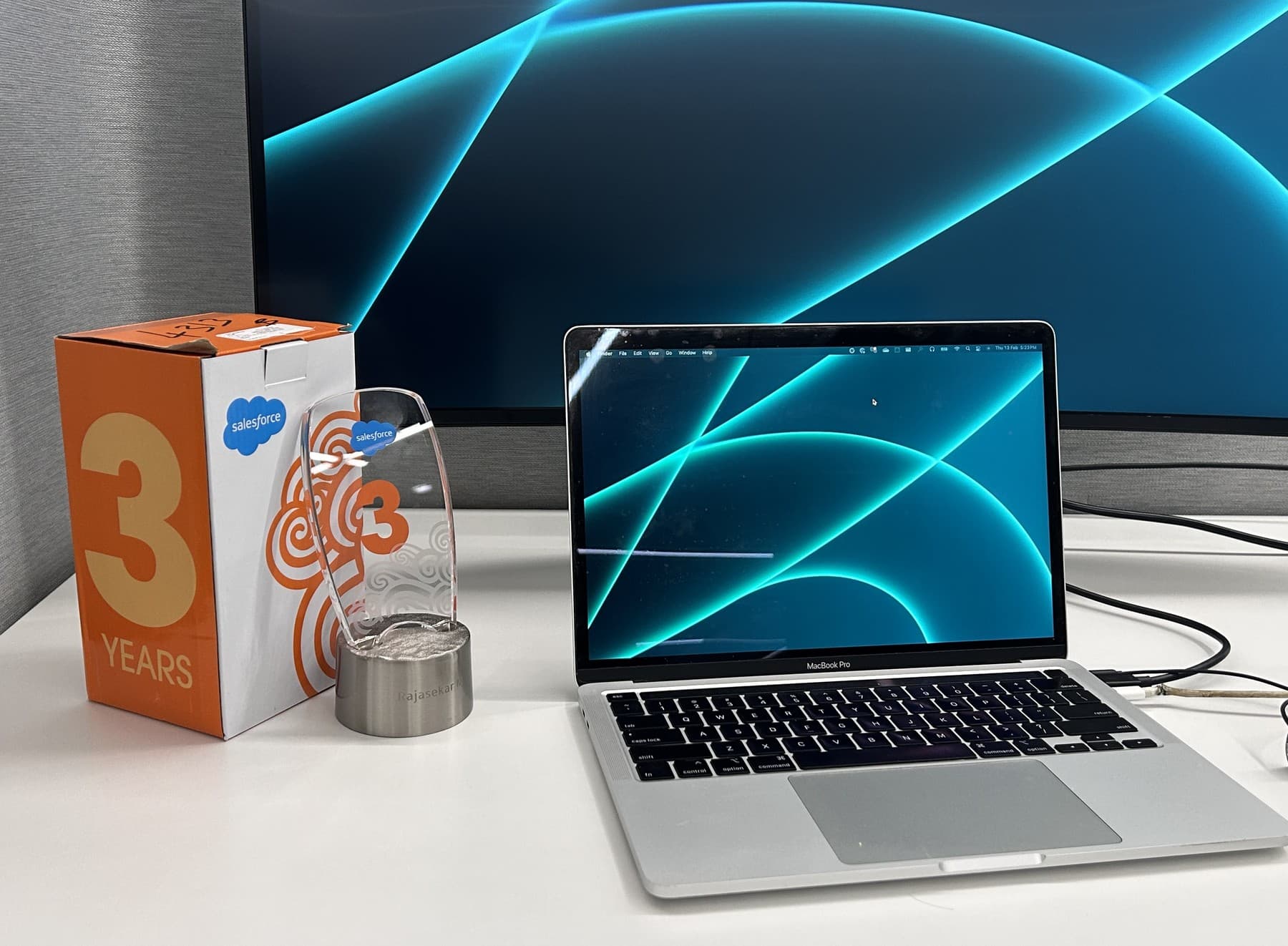 A three-year Salesforce service anniversary award on Rajasekar's desk